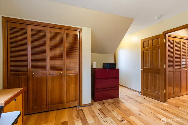 a bathroom with a granite countertop toilet sink and mirror
