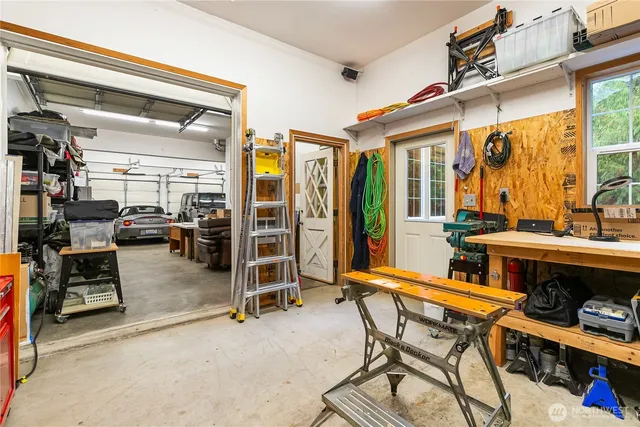a backyard of a house with barbeque oven table and chairs