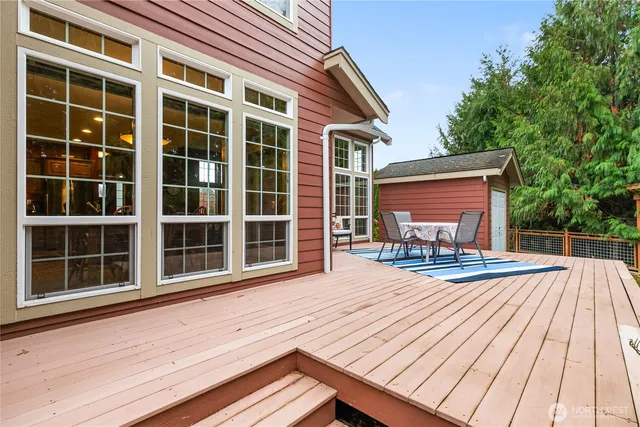 a view of a chairs and table on the wooden deck