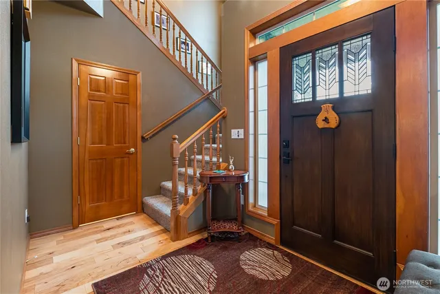 a view of an entryway with wooden floor