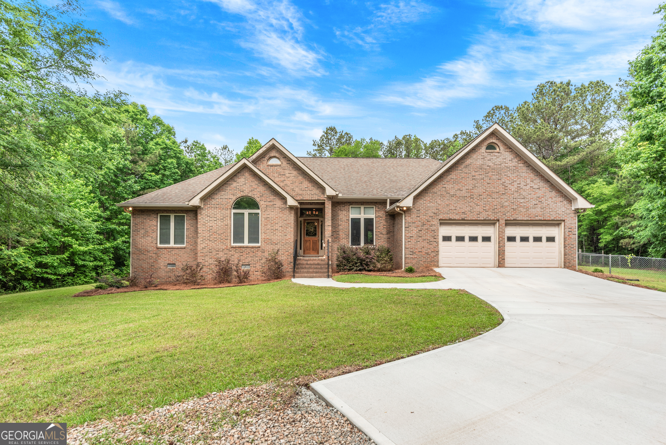 1370 Deerwood Drive Rutledge, GA 30663 - Photo 1 of 43 a front view of a house with a yard and garage