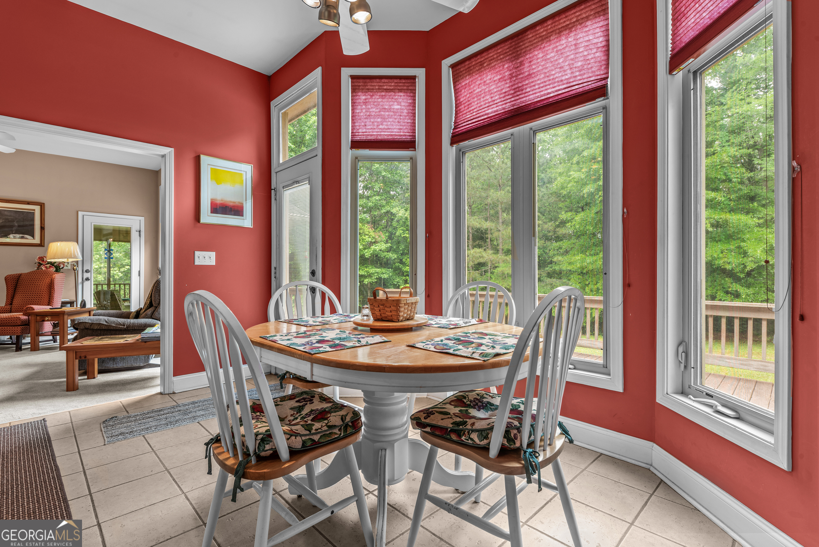 1370 Deerwood Drive Rutledge, GA 30663 - Photo 11 of 43 a dining room with furniture large windows and wooden floor