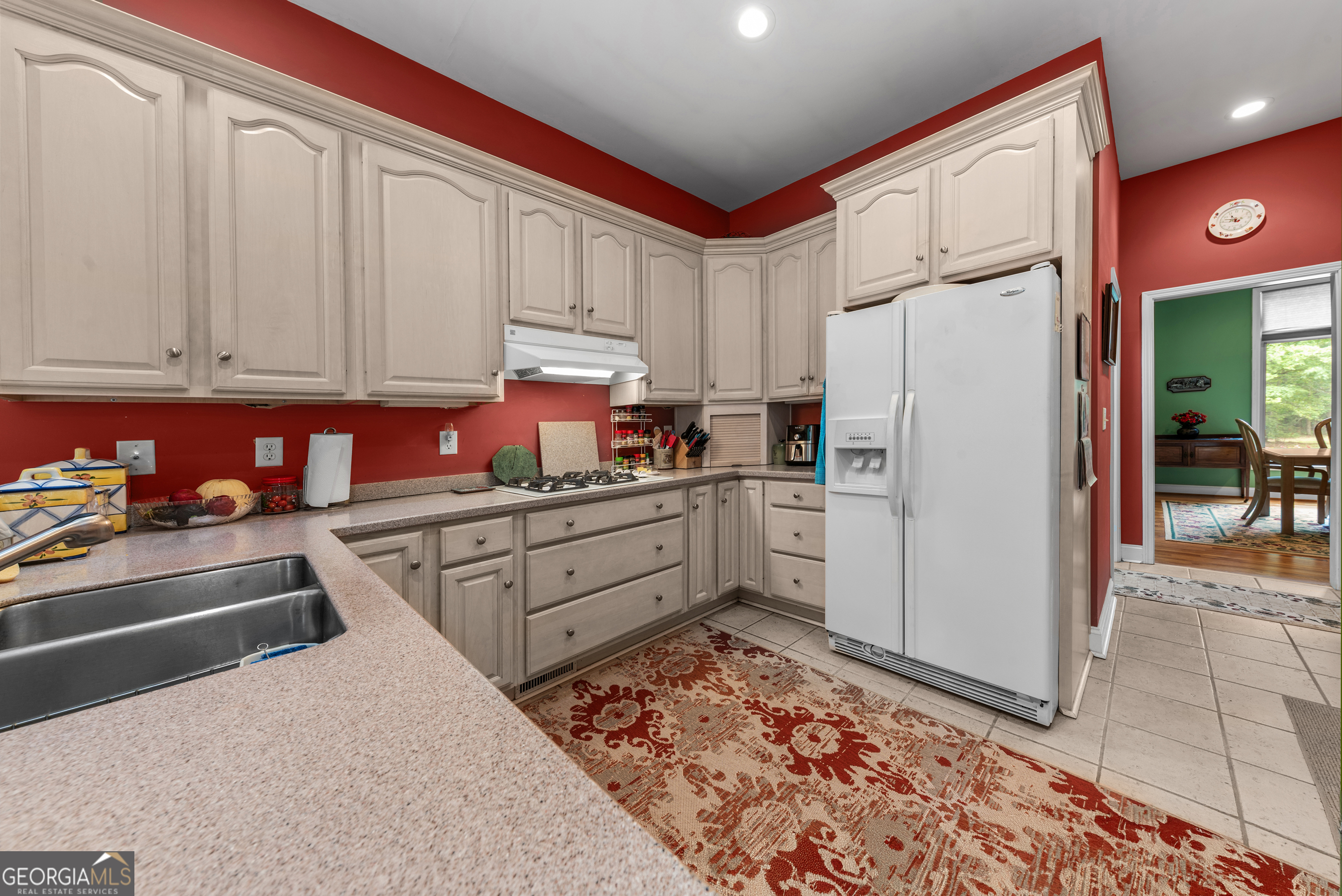1370 Deerwood Drive Rutledge, GA 30663 - Photo 13 of 43 a kitchen with stainless steel appliances granite countertop a refrigerator sink and cabinets