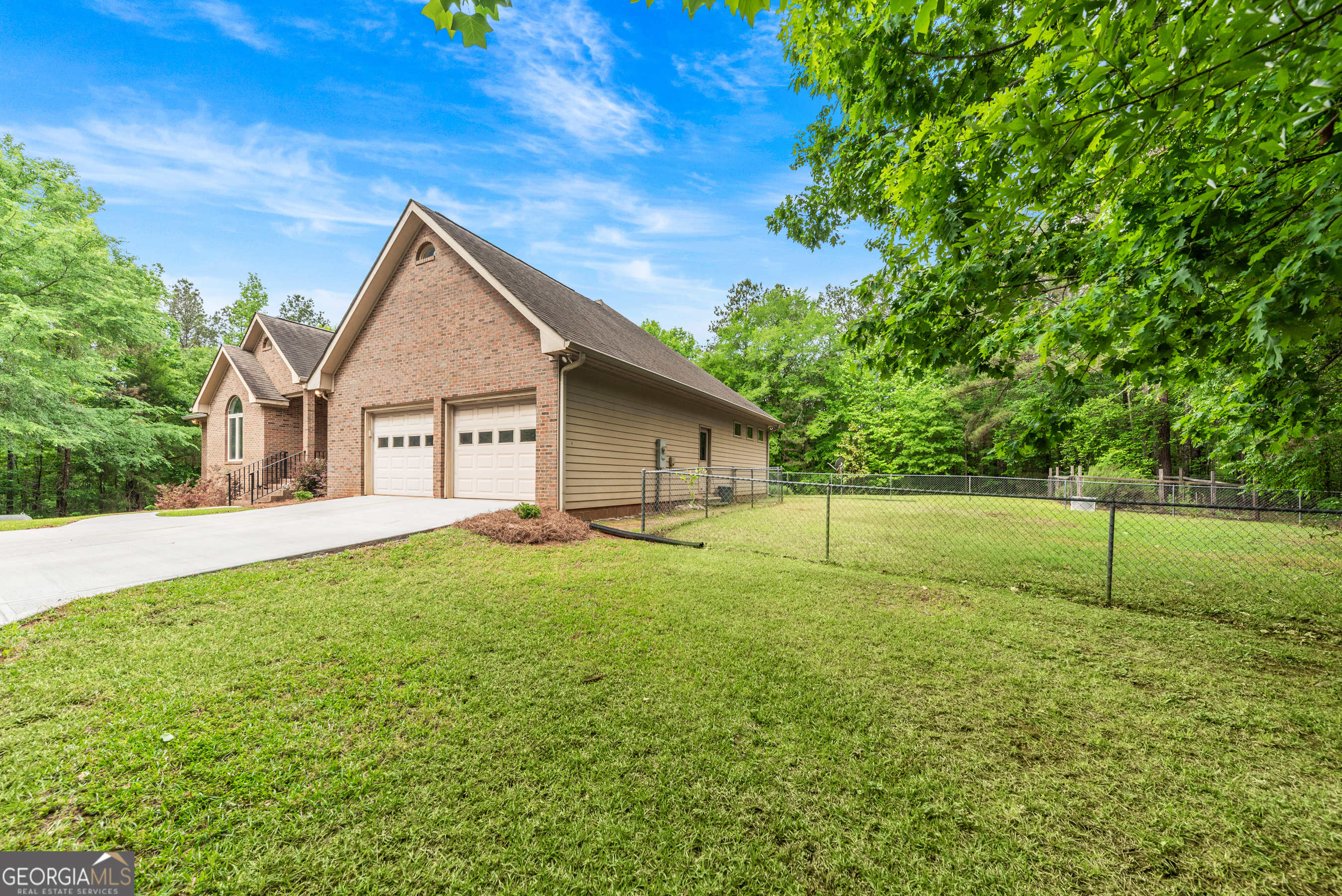 1370 Deerwood Drive Rutledge, GA 30663 - Photo 41 of 43 a backyard of a house with plants and large tree