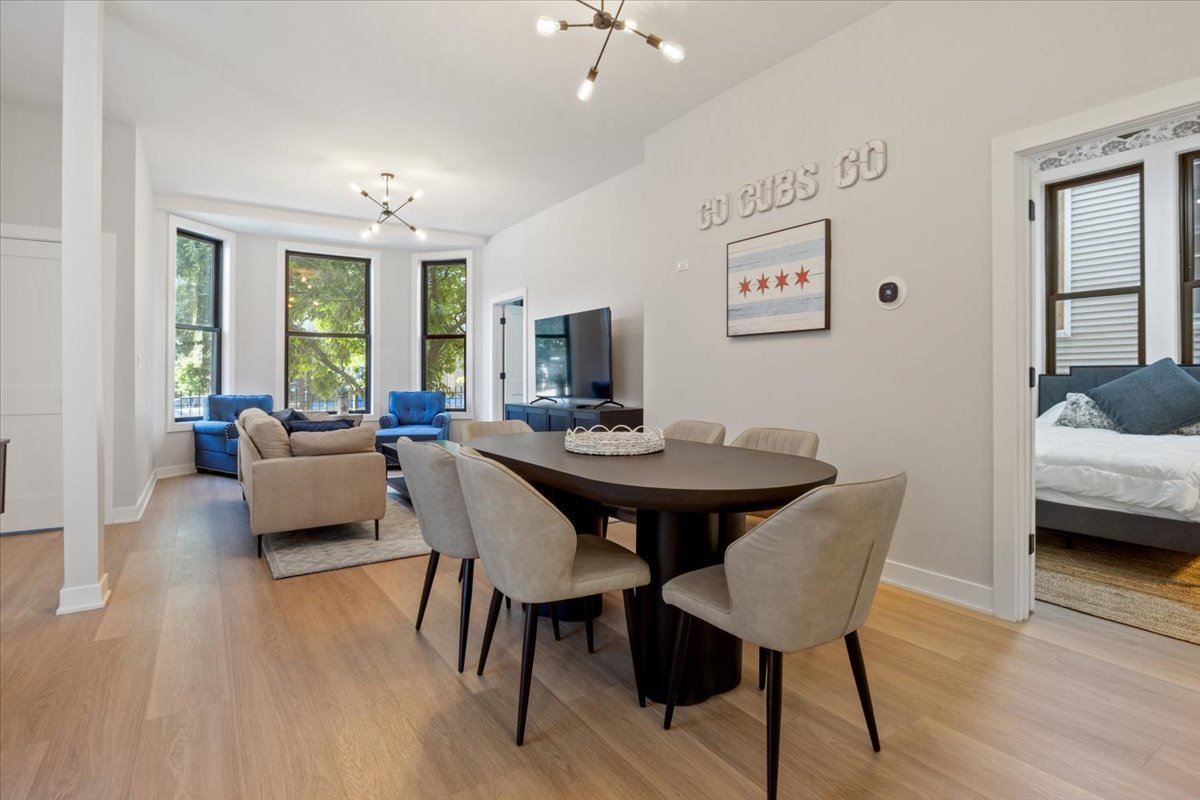 1110 West Addison Street Chicago, IL 60613 - Photo 11 of 49 a view of a dining room with furniture and wooden floor