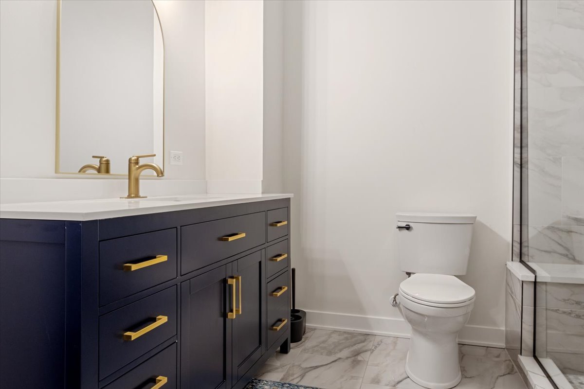 1110 West Addison Street Chicago, IL 60613 - Photo 15 of 49 a bathroom with a sink a toilet and a mirror