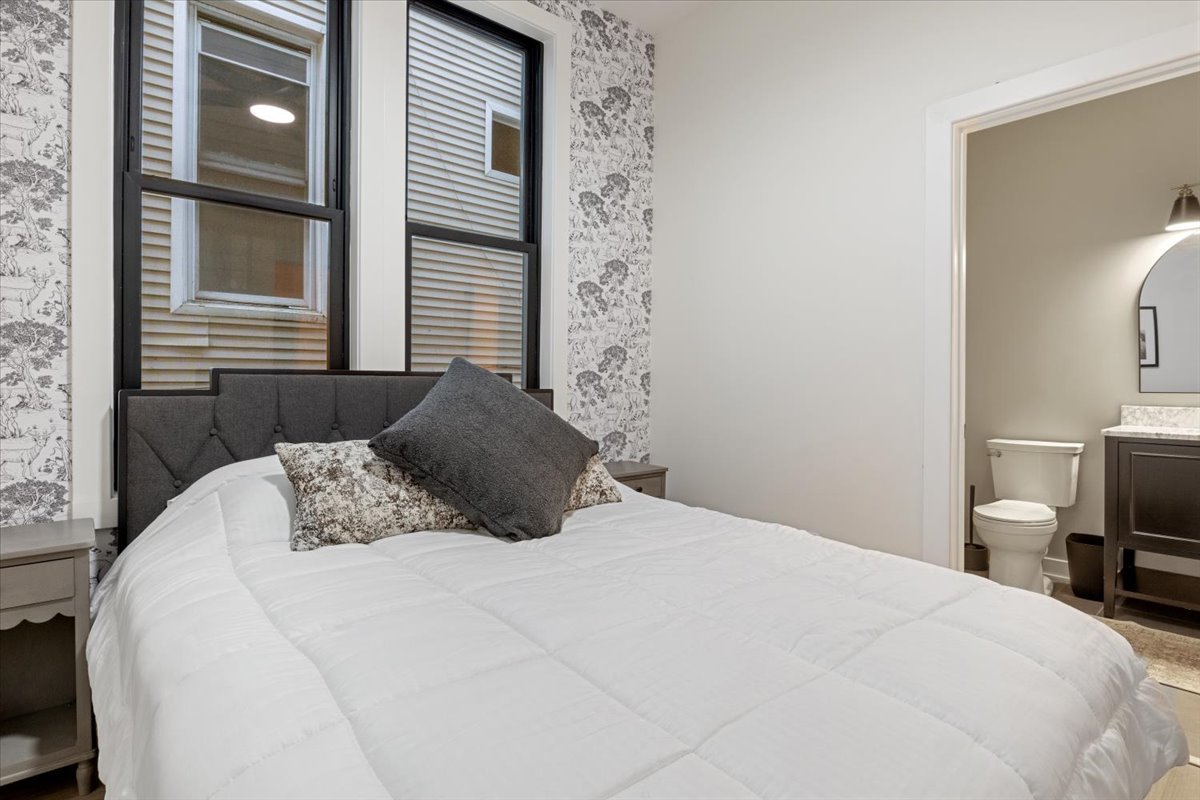 1110 West Addison Street Chicago, IL 60613 - Photo 19 of 49 a bedroom with a bed and a tv on a stool