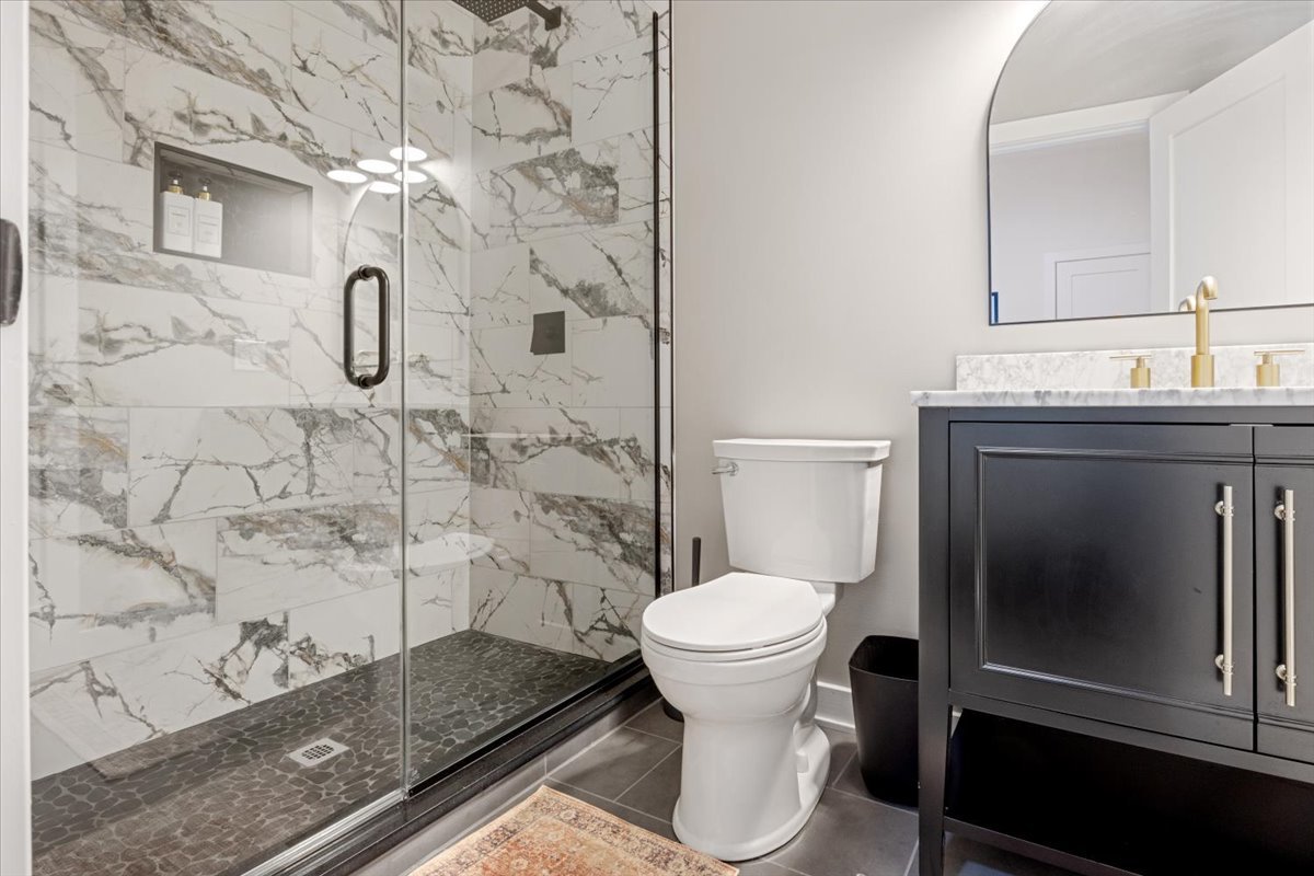 1110 West Addison Street Chicago, IL 60613 - Photo 20 of 49 a bathroom with a granite countertop sink toilet and shower