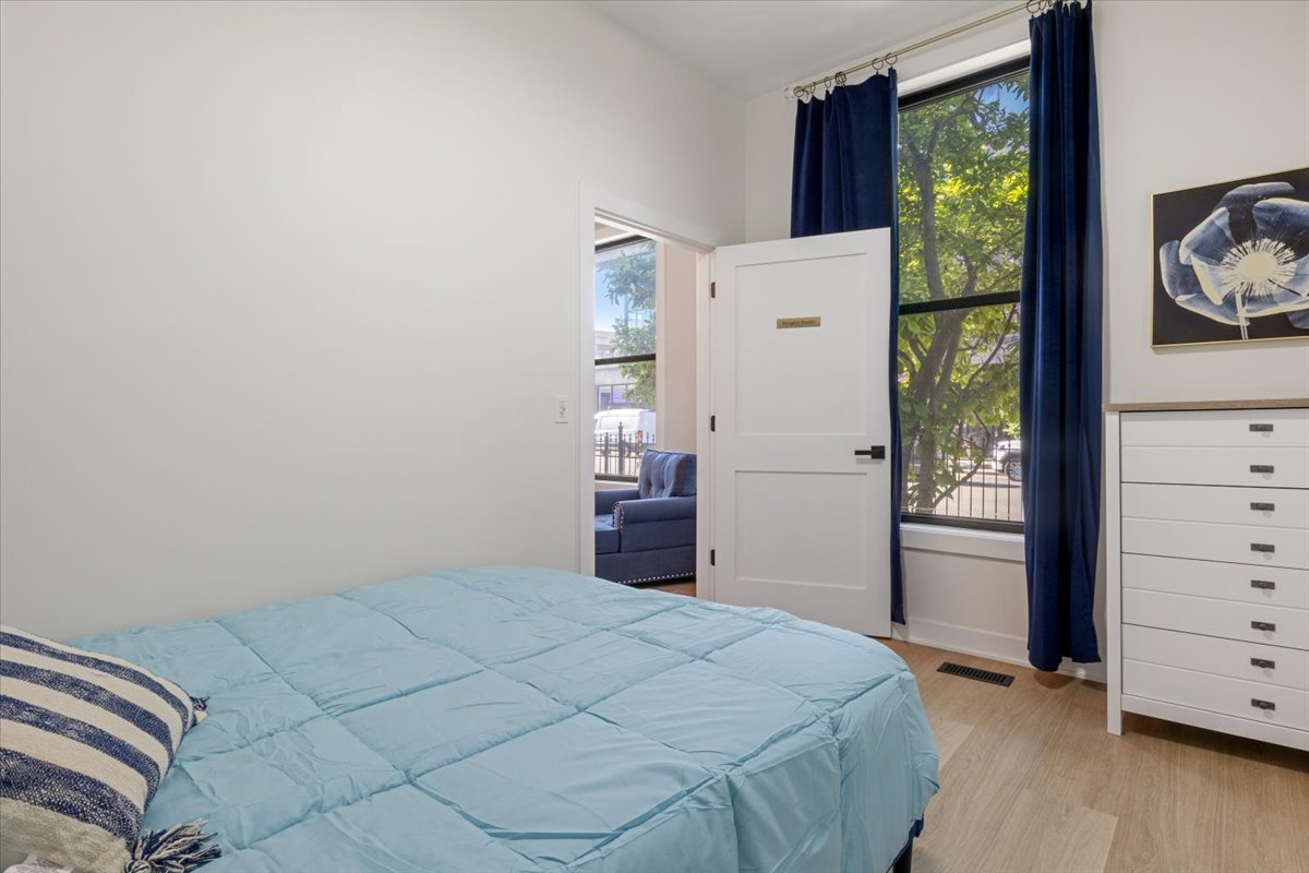 1110 West Addison Street Chicago, IL 60613 - Photo 24 of 49 a bedroom with a bed and a dresser