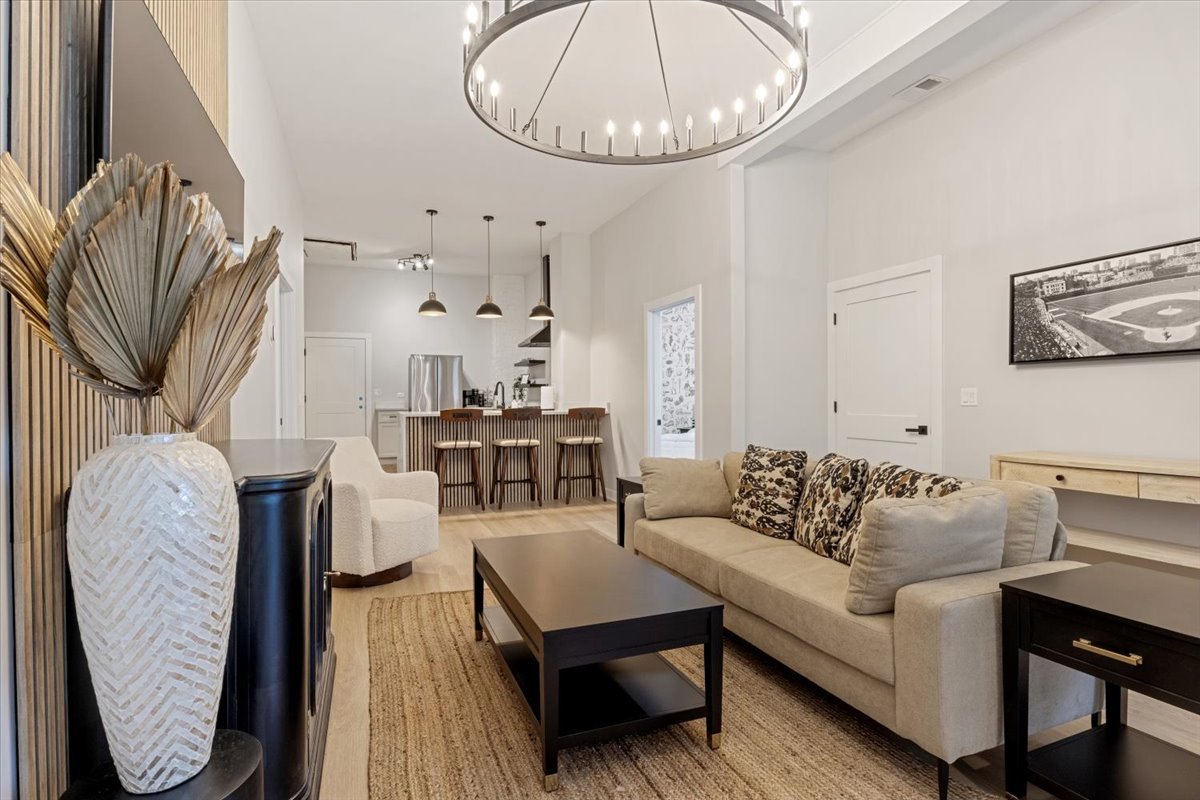 1110 West Addison Street Chicago, IL 60613 - Photo 26 of 49 a living room with furniture a table and wooden floor