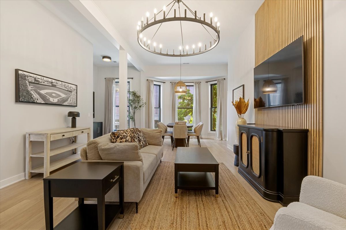 1110 West Addison Street Chicago, IL 60613 - Photo 30 of 49 a living room with furniture a fireplace and a flat screen tv