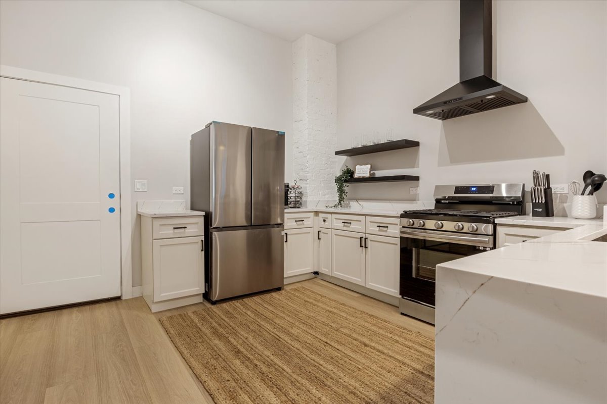 1110 West Addison Street Chicago, IL 60613 - Photo 31 of 49 a kitchen with stainless steel appliances a refrigerator a stove and a sink