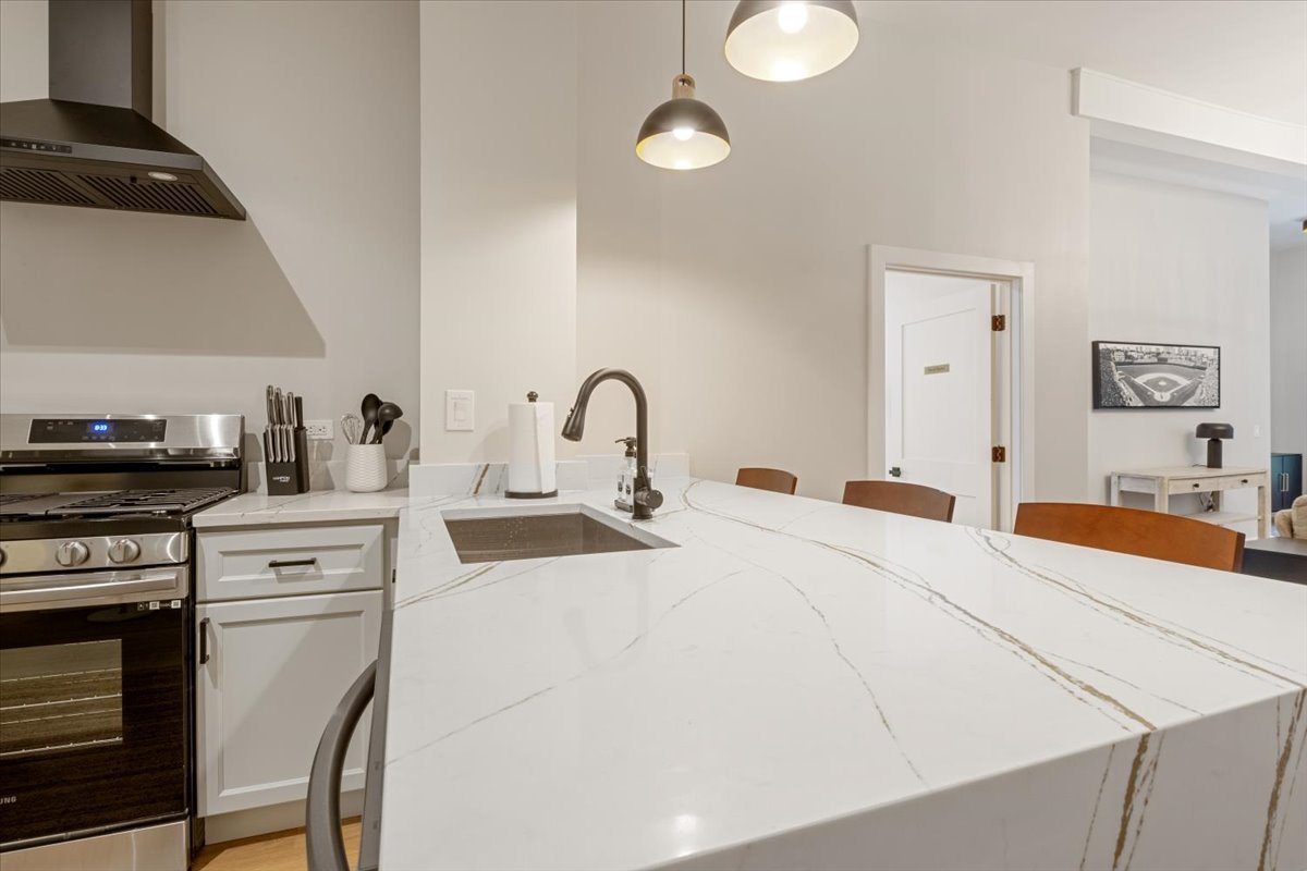1110 West Addison Street Chicago, IL 60613 - Photo 33 of 49 a kitchen with a sink a stove and cabinets