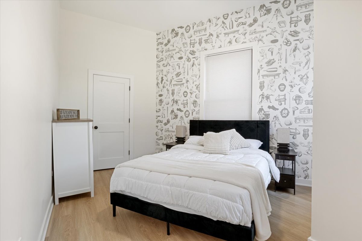 1110 West Addison Street Chicago, IL 60613 - Photo 34 of 49 a bedroom with a bed and a mirror