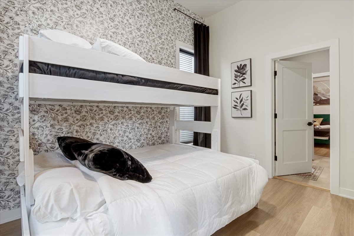 1110 West Addison Street Chicago, IL 60613 - Photo 36 of 49 a bedroom with a bed and a wall painting