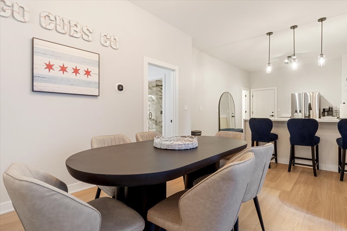 1110 West Addison Street Chicago, IL 60613 - Photo 6 of 49 a view of a dining room with furniture and wooden floor