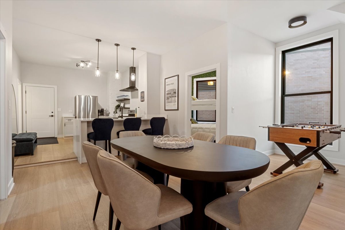 1110 West Addison Street Chicago, IL 60613 - Photo 9 of 49 a view of a dining room with furniture and wooden floor