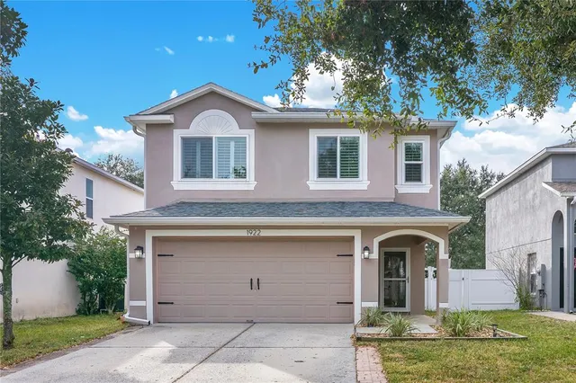 front view of a house with a tree