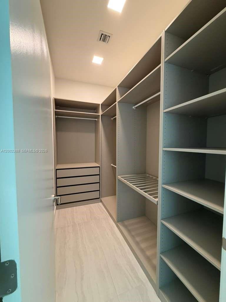 77 Southeast 5th Street, Unit 1208 Miami, FL 33131 - Photo 11 of 32 a view of walk in closet with empty racks