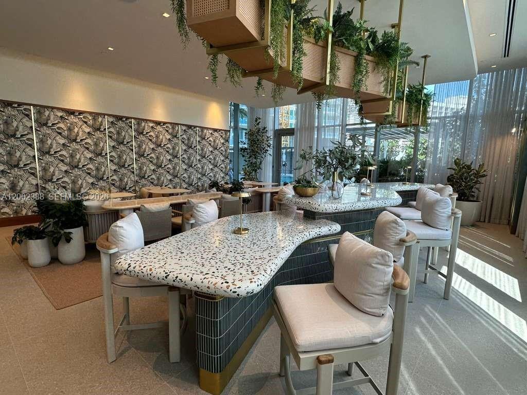 77 Southeast 5th Street, Unit 1208 Miami, FL 33131 - Photo 15 of 32 a outdoor space with lots of chairs and a couch