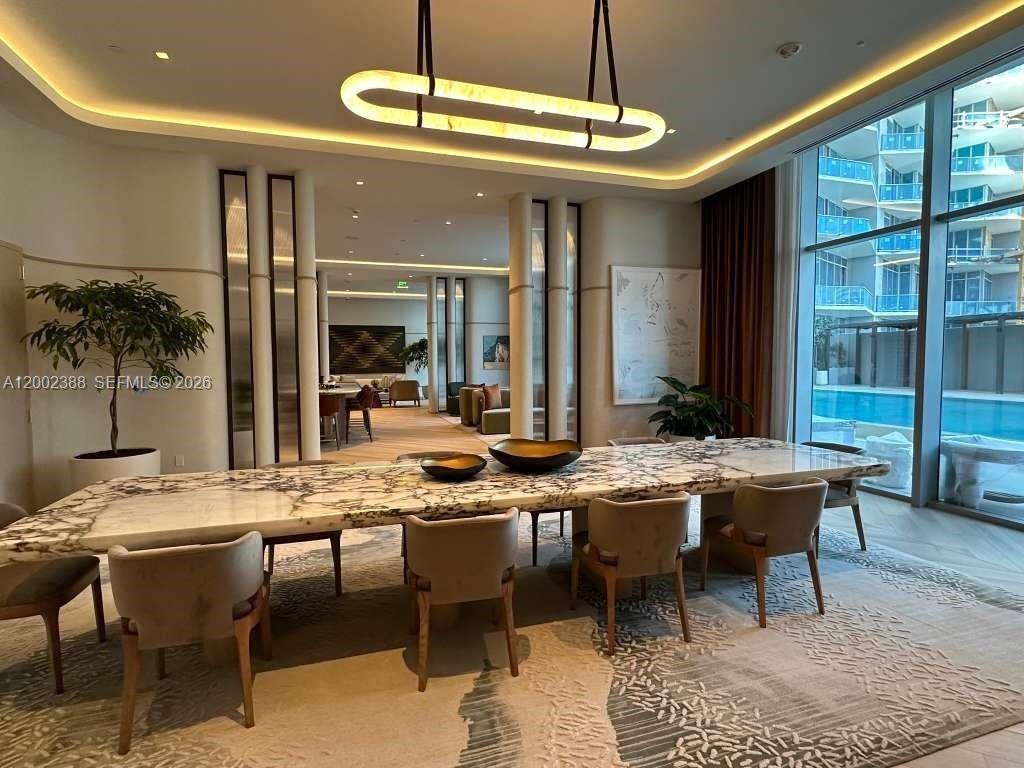 77 Southeast 5th Street, Unit 1208 Miami, FL 33131 - Photo 18 of 32 a view of a dining room with furniture window and wooden floor