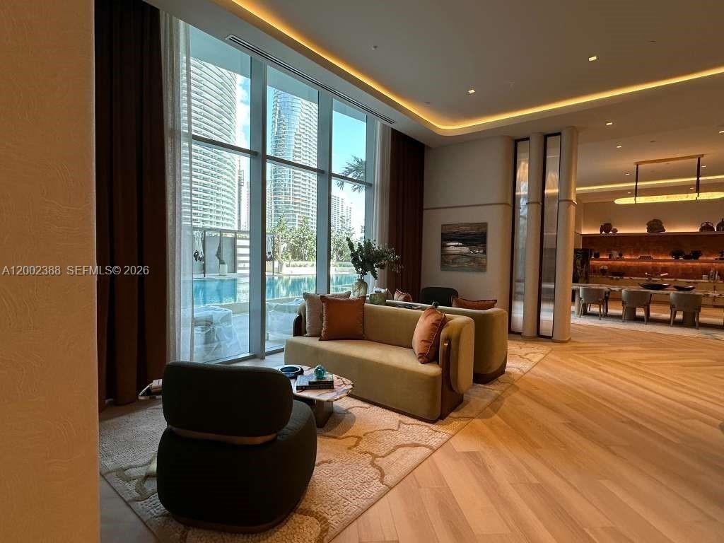 77 Southeast 5th Street, Unit 1208 Miami, FL 33131 - Photo 19 of 32 a living room with furniture and a large window