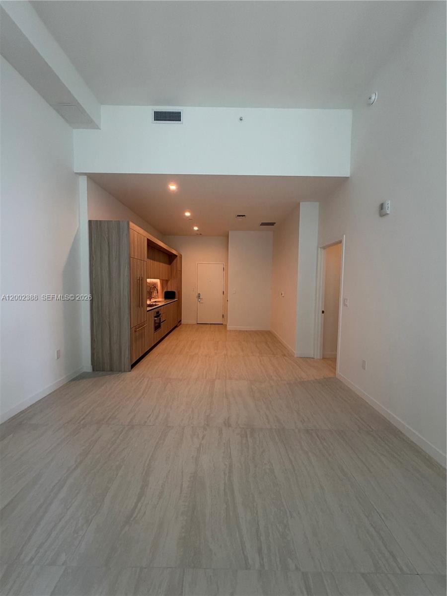 77 Southeast 5th Street, Unit 1208 Miami, FL 33131 - Photo 3 of 32 a view of empty room with wooden floor