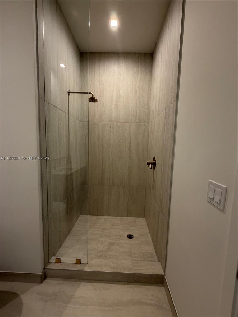 77 Southeast 5th Street, Unit 1208 Miami, FL 33131 - Photo 8 of 32 a bathroom with a shower