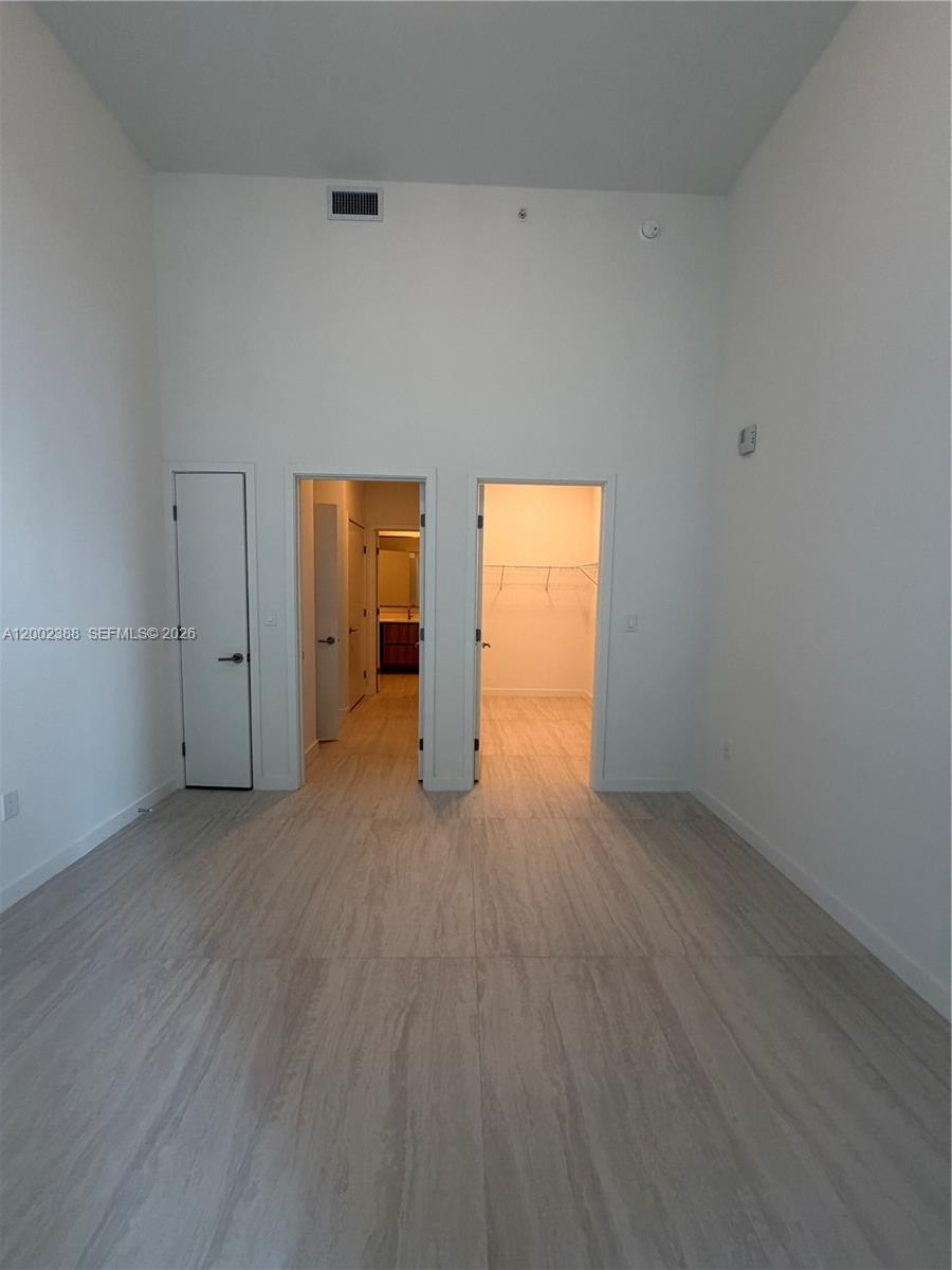 77 Southeast 5th Street, Unit 1208 Miami, FL 33131 - Photo 9 of 32 a view of an empty room and window
