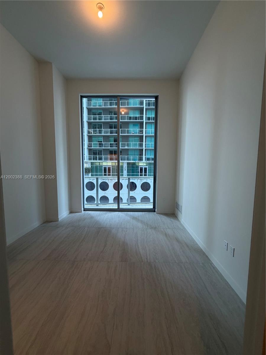 77 Southeast 5th Street, Unit 1208 Miami, FL 33131 - Photo 10 of 32 a view of an empty room with a window