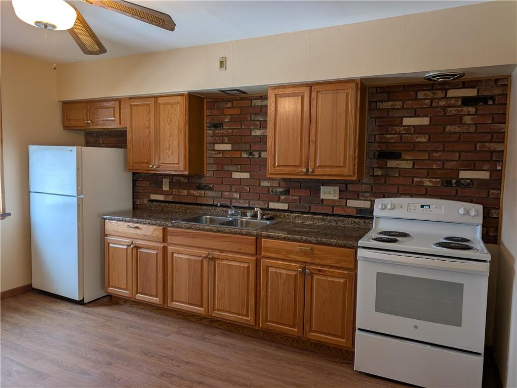 619 Conrad Avenue, Unit 2 Charleroi, PA 15022 - Photo 2 of 8 a kitchen with a stove cabinets and a refrigerator