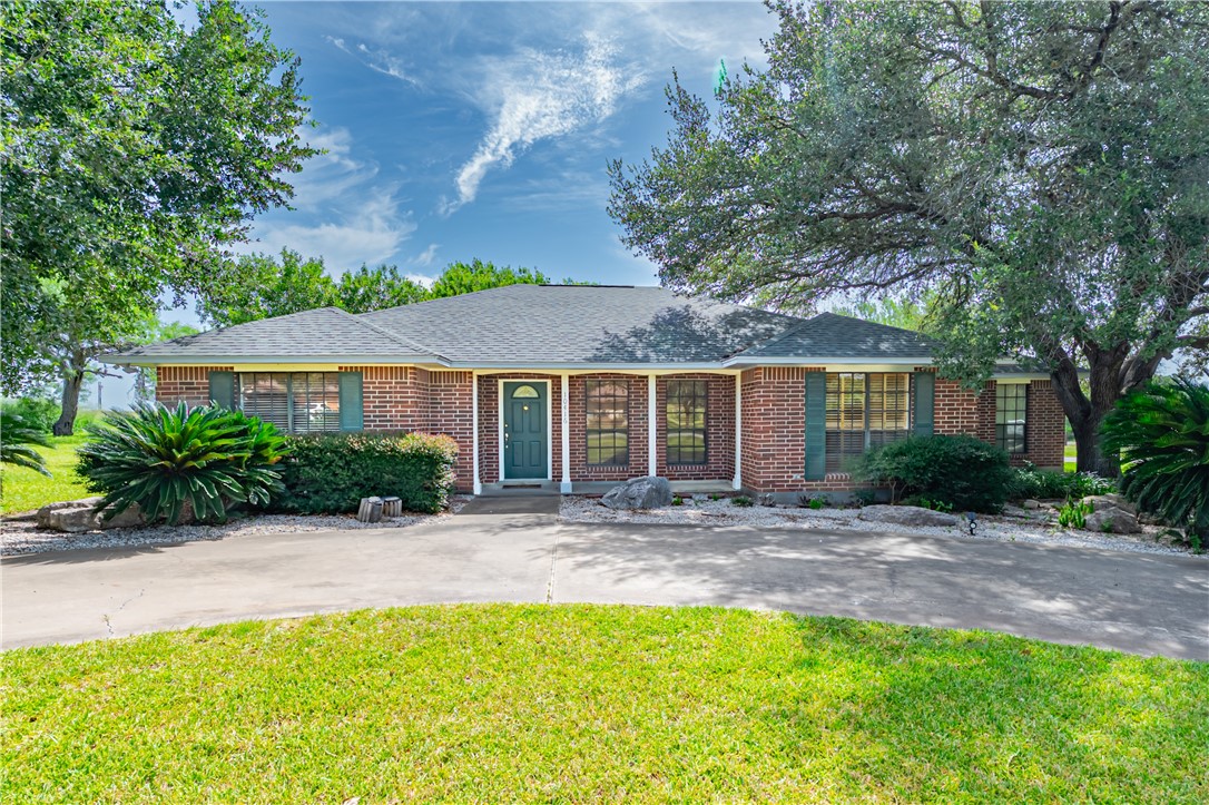 a front view of a house with a garden and patio