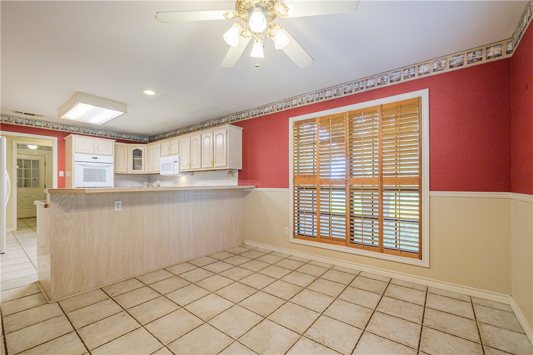 10416 7th Street Pettus, TX 78146 - Photo 12 of 40 a kitchen with stainless steel appliances granite countertop a stove a sink and a microwave