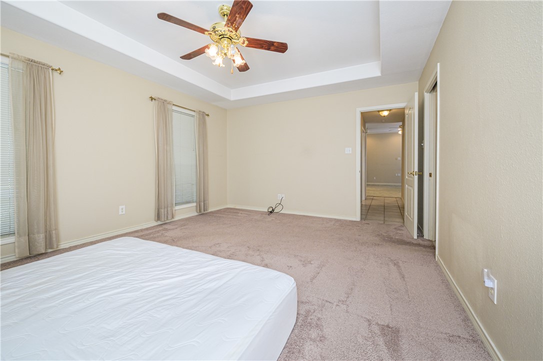 10416 7th Street Pettus, TX 78146 - Photo 15 of 40 a bedroom with a bed and a chandelier