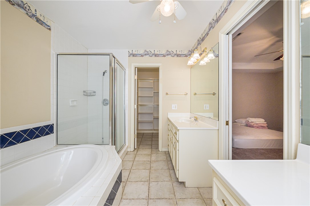 10416 7th Street Pettus, TX 78146 - Photo 17 of 40 a bathroom with a tub sink and mirror