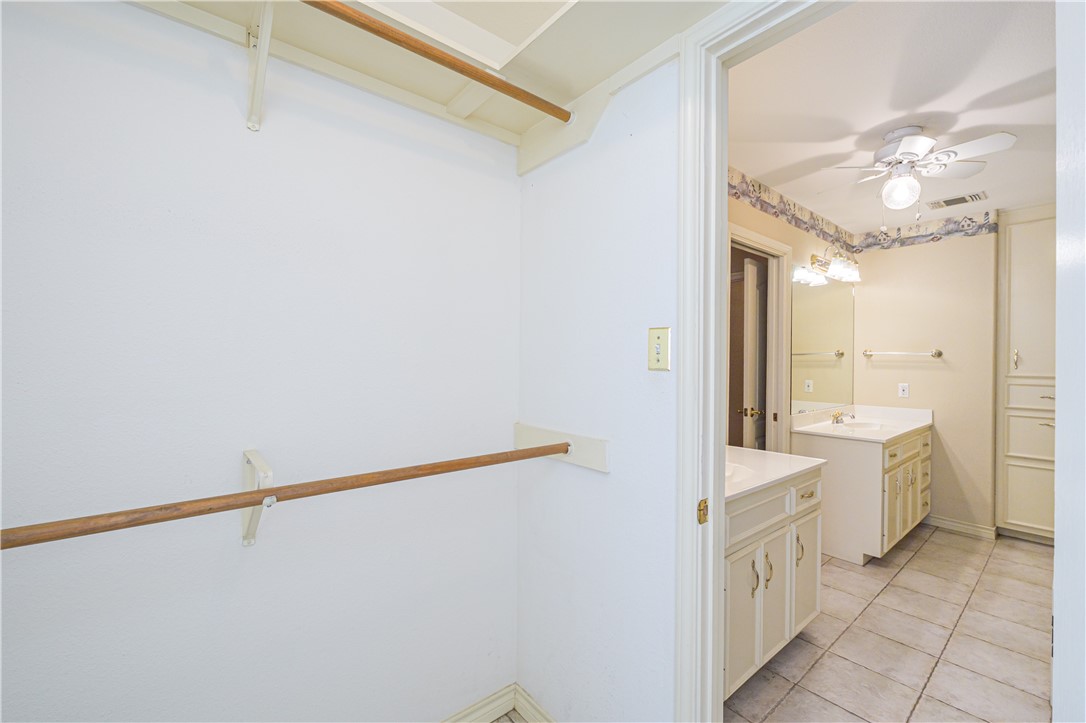 10416 7th Street Pettus, TX 78146 - Photo 19 of 40 a bathroom with a double vanity sink a toilet and a mirror
