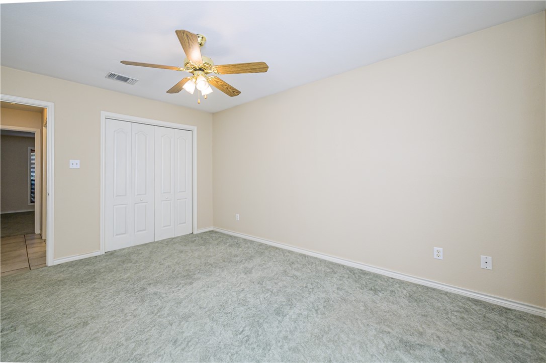 10416 7th Street Pettus, TX 78146 - Photo 22 of 40 an empty room with a ceiling fan and a window
