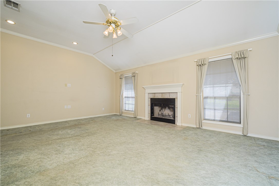 10416 7th Street Pettus, TX 78146 - Photo 7 of 40 a view of an empty room with a fireplace and a window