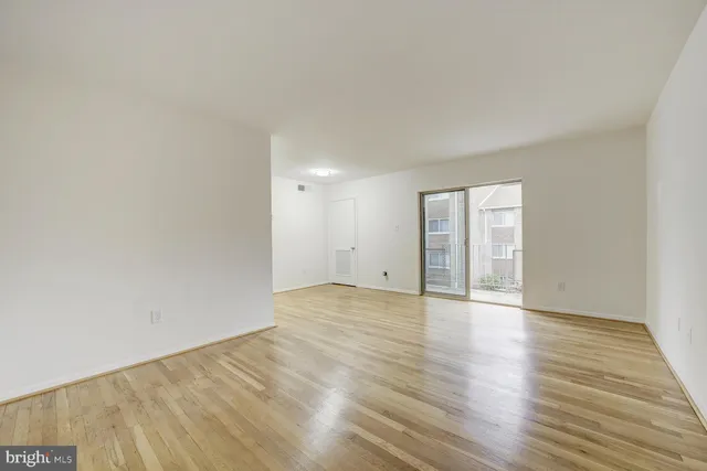 a view of an empty room and wooden floor