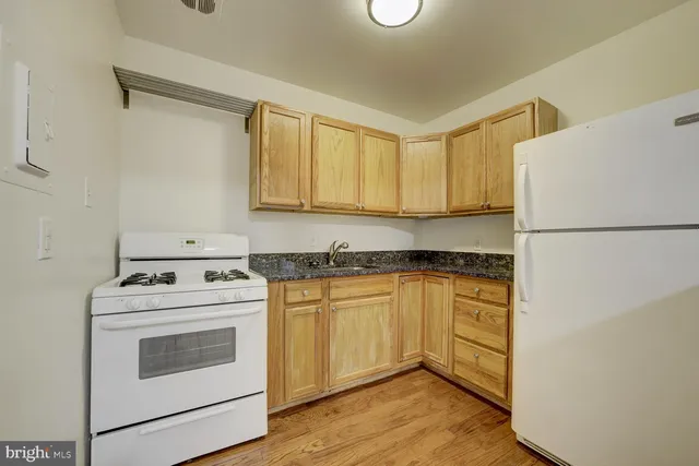 a kitchen with a white cabinets and white appliances