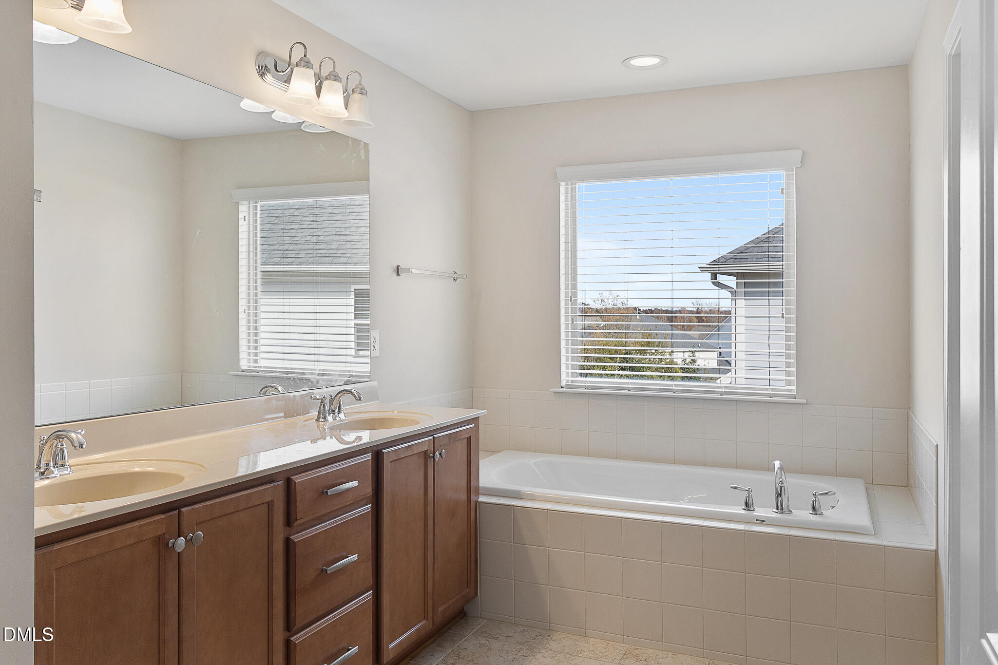 4249 Saubranch Hill Street Raleigh, NC 27616 - Photo 22 of 31 a bathroom with a tub sink double vanity and a window