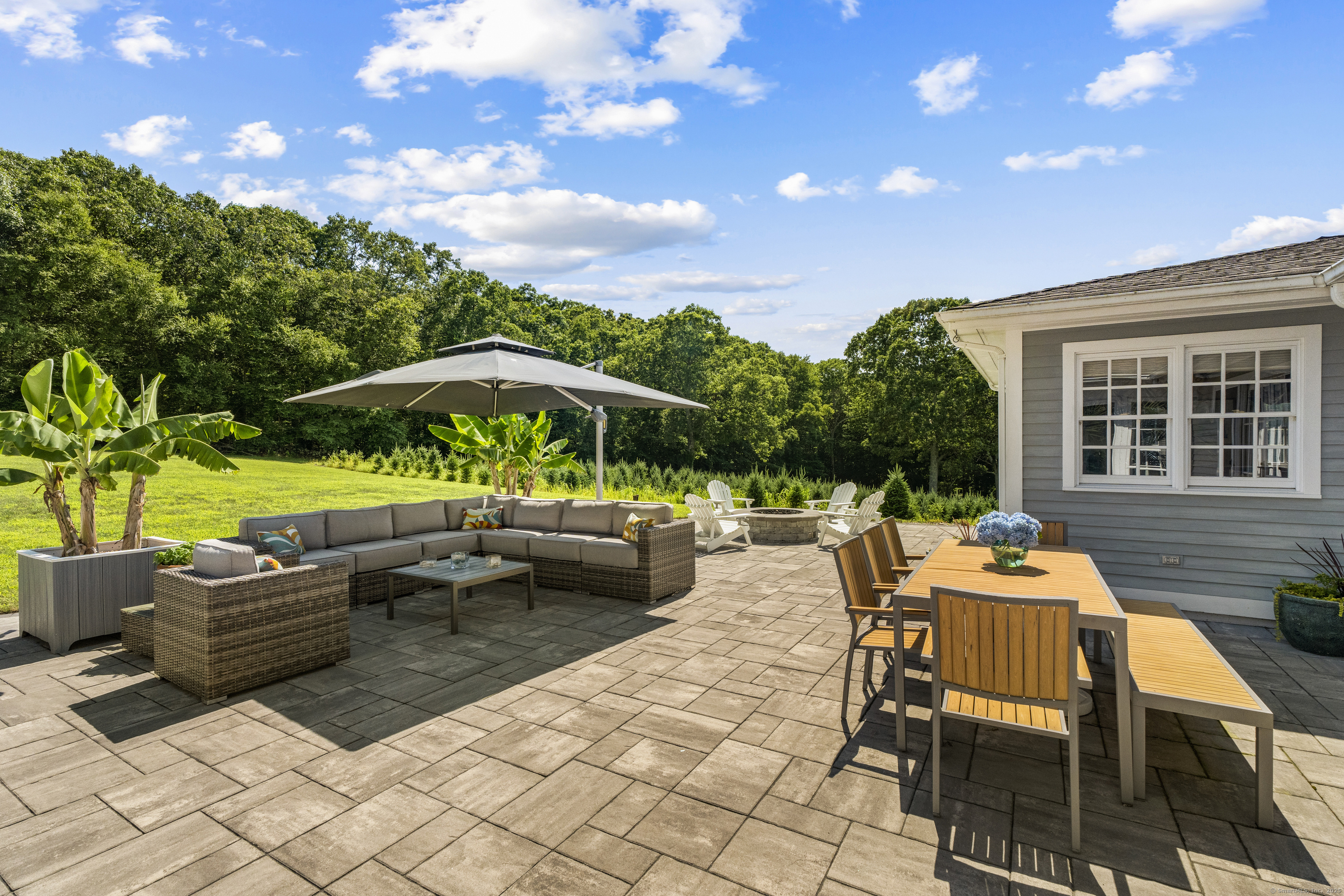 57 Northwest Corner Road Preston, CT 06365 - Photo 5 of 40 a backyard of a house with barbeque oven table and chairs