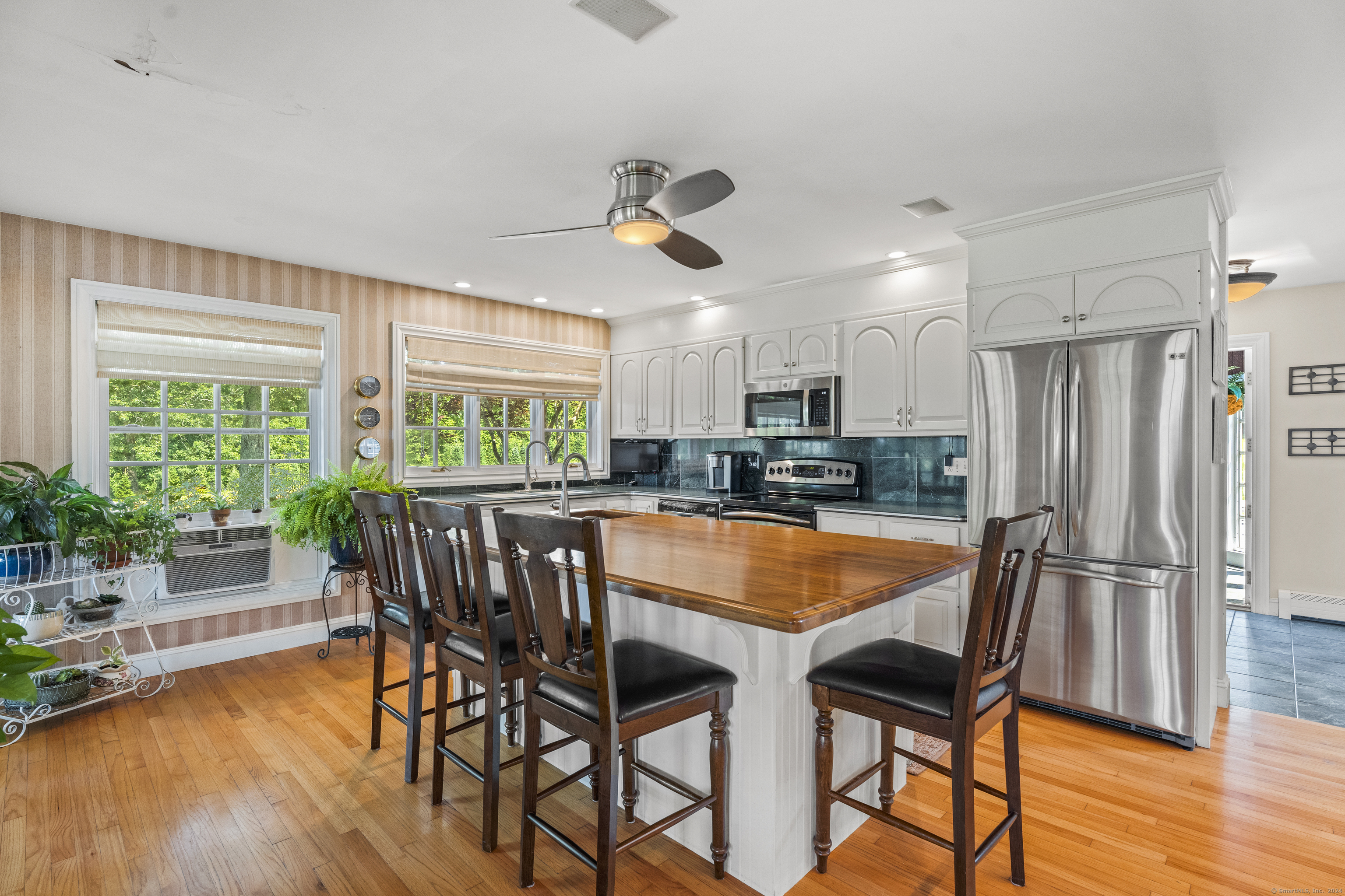 57 Northwest Corner Road Preston, CT 06365 - Photo 7 of 40 a kitchen with stainless steel appliances granite countertop dining table chairs and wooden floor