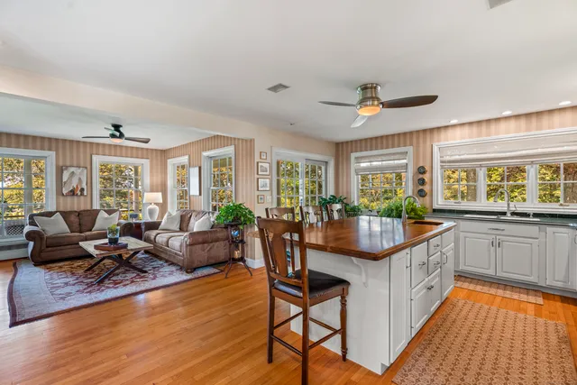 a kitchen with granite countertop lots of counter top space and living room