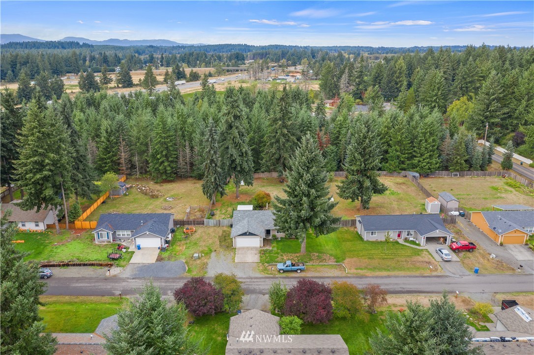 5418 187th Court Southwest Rochester, WA 98579 - Photo 2 of 24 an aerial view of residential houses with outdoor space and swimming pool