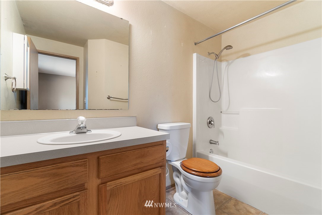 5418 187th Court Southwest Rochester, WA 98579 - Photo 12 of 24 a bathroom with a sink a toilet and a mirror