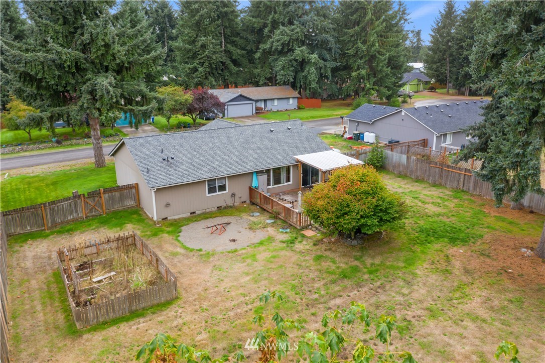 5418 187th Court Southwest Rochester, WA 98579 - Photo 22 of 24 an aerial view of a house with backyard space and balcony
