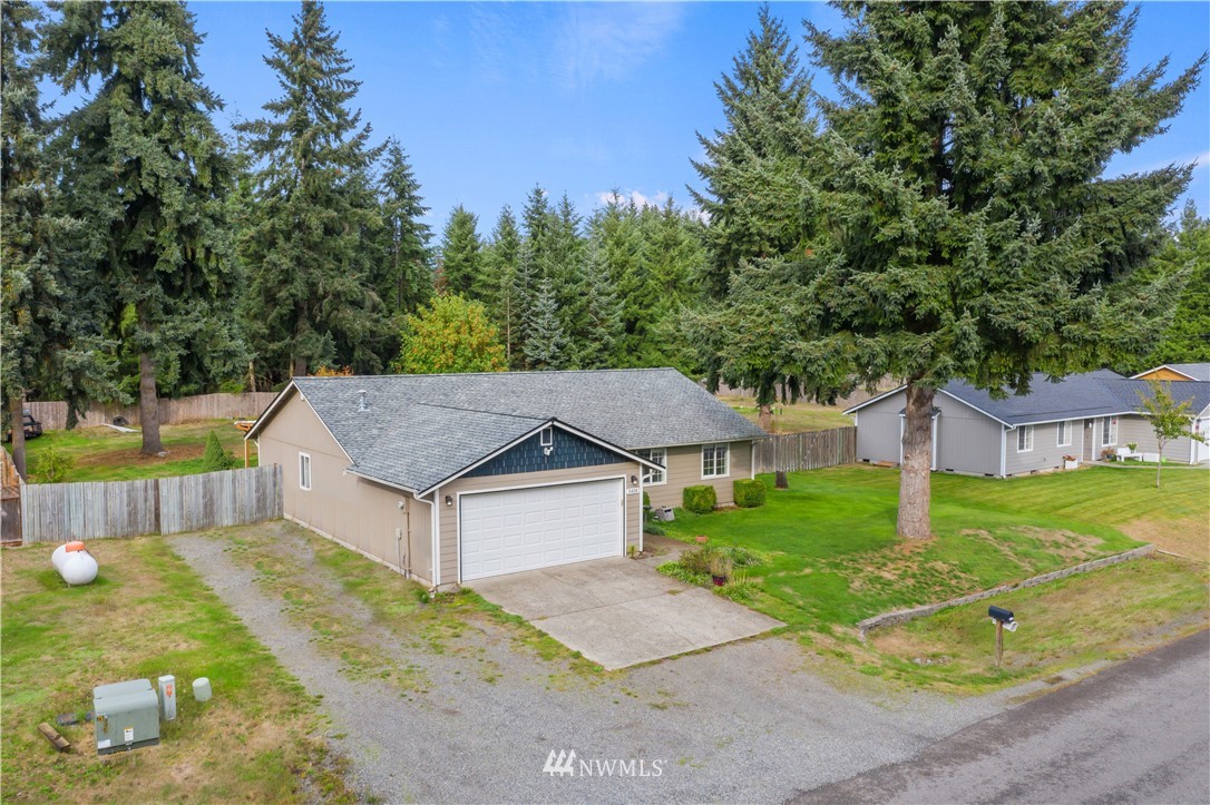 5418 187th Court Southwest Rochester, WA 98579 - Photo 23 of 24 a aerial view of a house with a yard and large trees