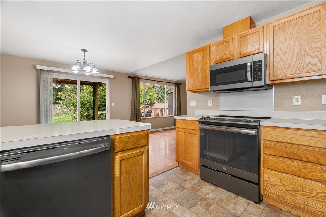 5418 187th Court Southwest Rochester, WA 98579 - Photo 8 of 24 a kitchen with stainless steel appliances granite countertop a stove and a microwave