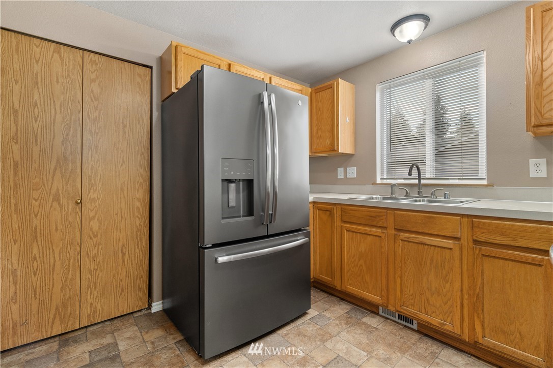 5418 187th Court Southwest Rochester, WA 98579 - Photo 9 of 24 a kitchen with stainless steel appliances granite countertop a refrigerator and a sink